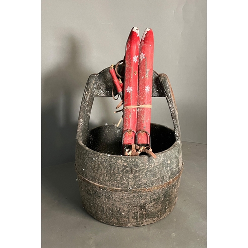 320 - A wooden well bucket with metal banding along with wooden decorative skis glued in places