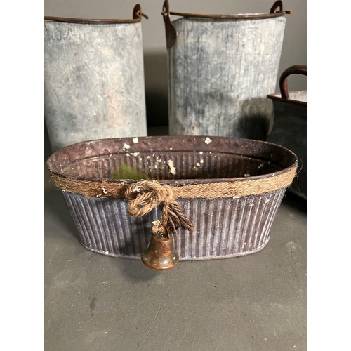 323 - A selection of galvanised pots and planters