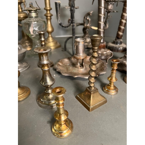 335 - A large selection of candle sticks various sizes and ages