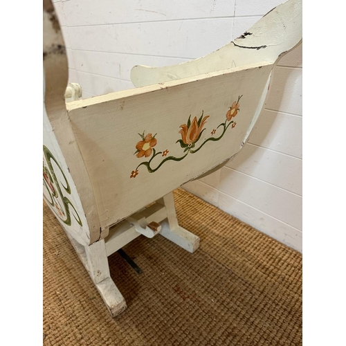 349 - A hand painted swan sleigh, the sleigh is decorated with a hand painted floral motif and the runners... 