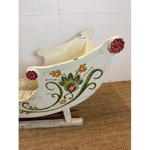 349 - A hand painted swan sleigh, the sleigh is decorated with a hand painted floral motif and the runners... 