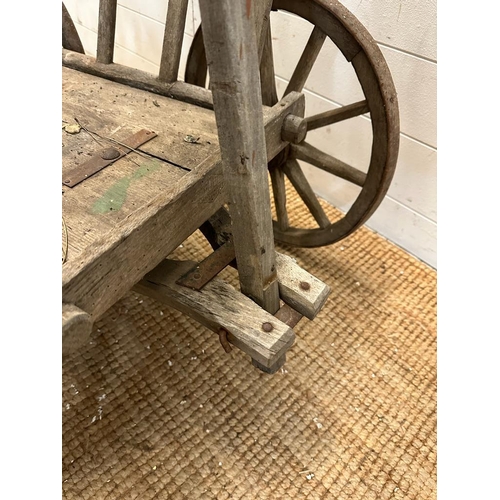 350 - A vintage wooden garden trolley on wooden metal bound wheels