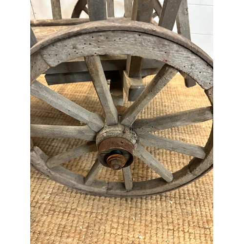 350 - A vintage wooden garden trolley on wooden metal bound wheels