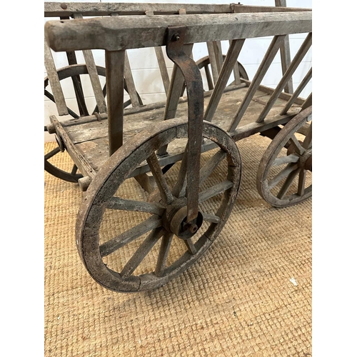 350 - A vintage wooden garden trolley on wooden metal bound wheels