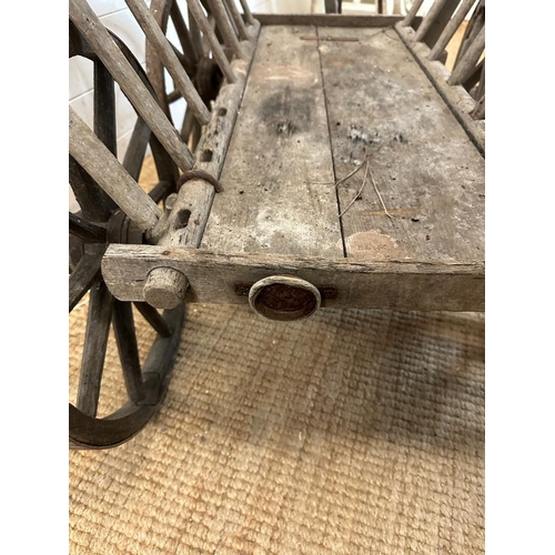 350 - A vintage wooden garden trolley on wooden metal bound wheels