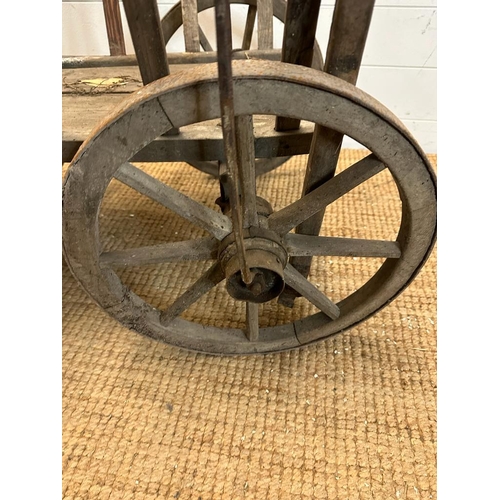 353 - A vintage wooden dog cart or garden trolley with metal bound wheels