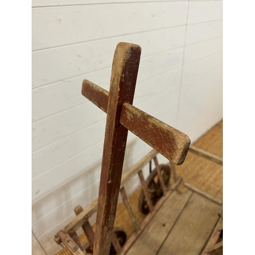 354 - A vintage wooden dog cart or garden trolley with metal bound wheels