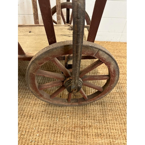 354 - A vintage wooden dog cart or garden trolley with metal bound wheels