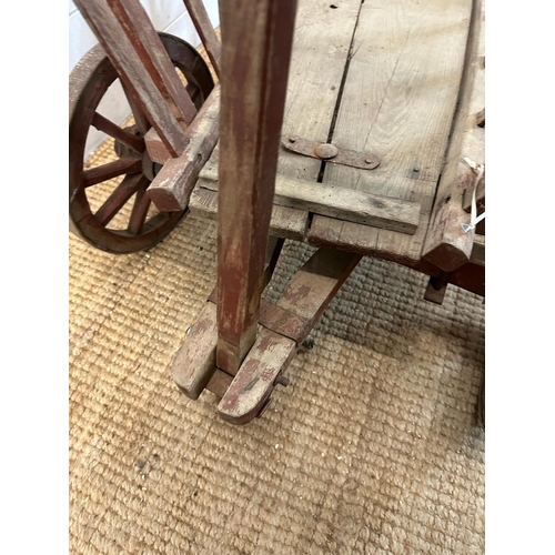 354 - A vintage wooden dog cart or garden trolley with metal bound wheels