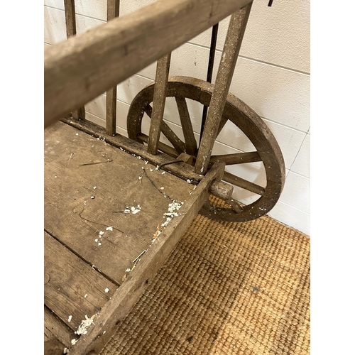 355 - A vintage wooden dog cart or garden trolley with metal bound wheels