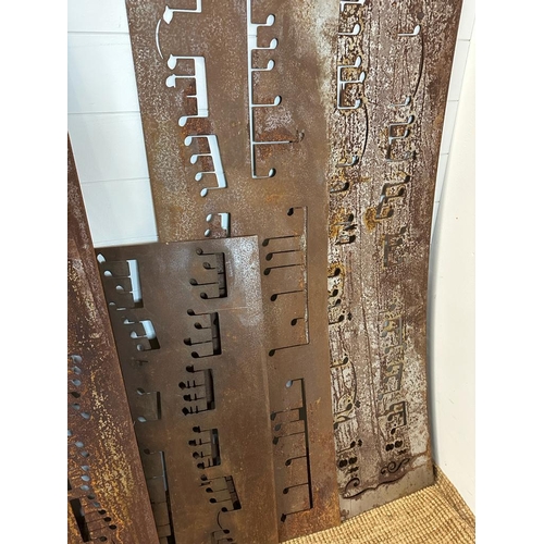 359 - Seventeen reclaimed metal sheets pierced with musical notes, various sizes