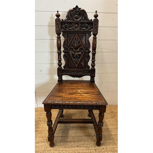 36 - A single oak Jacobean style hall chair with a carved lion back and turned supports finishing in deco... 