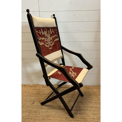 37 - A lacquered wooden folding campaign chair with red and white floral seat and back