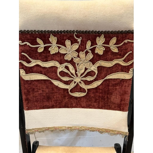 37 - A lacquered wooden folding campaign chair with red and white floral seat and back