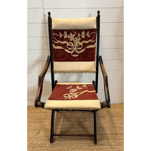 37 - A lacquered wooden folding campaign chair with red and white floral seat and back