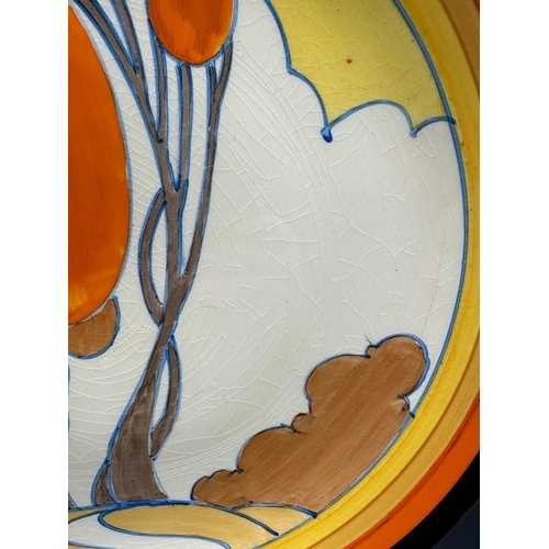 370 - A Clarice Cliff plate in the autumn pattern with central hand painted scene enclosed in bands AF