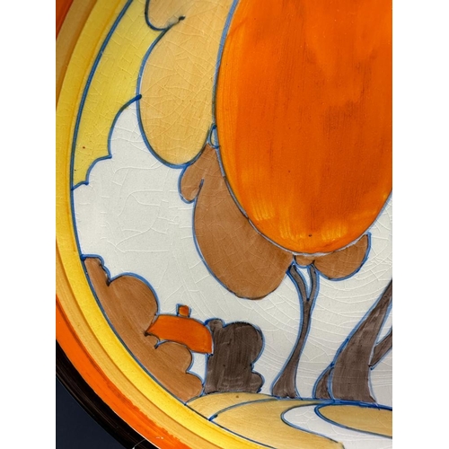 370 - A Clarice Cliff plate in the autumn pattern with central hand painted scene enclosed in bands AF