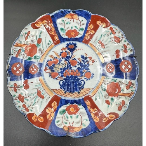 382 - Two Imari dishes with crimped rims and floral central motif