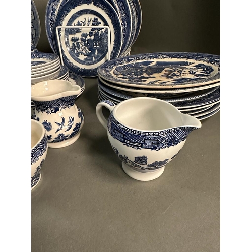 385 - A large quantity of blue and white china to include plates, platters and serving dishes