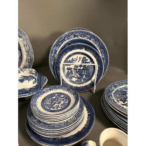 385 - A large quantity of blue and white china to include plates, platters and serving dishes