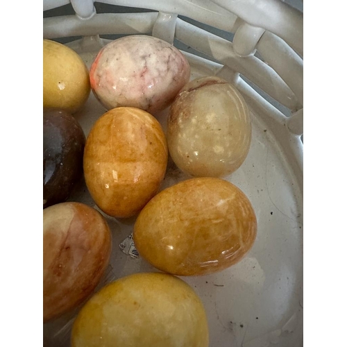 386 - A white ceramic basket and a selection of marble eggs