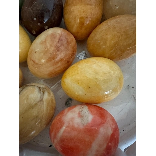 386 - A white ceramic basket and a selection of marble eggs