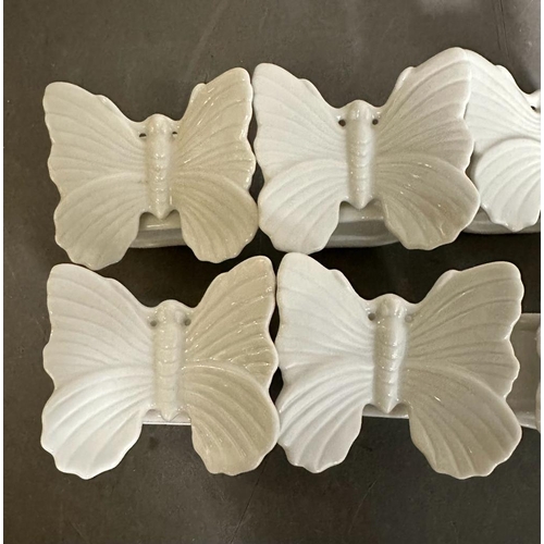 400 - A set of eight Fitz and Floyd butterfly while porcelain napkin rings