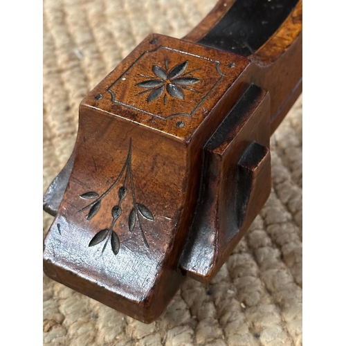 42 - An oval walnut centre table with ebonised inlay and pierced floral detail, on four splayed legs with... 