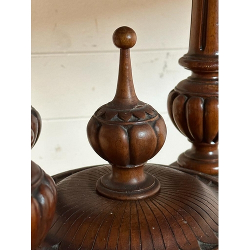 42 - An oval walnut centre table with ebonised inlay and pierced floral detail, on four splayed legs with... 