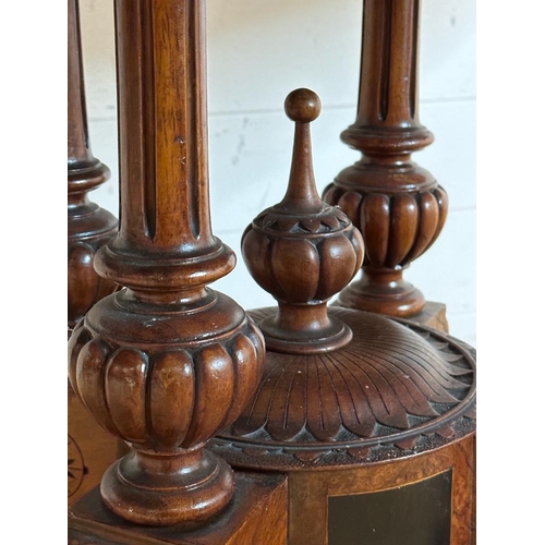 42 - An oval walnut centre table with ebonised inlay and pierced floral detail, on four splayed legs with... 