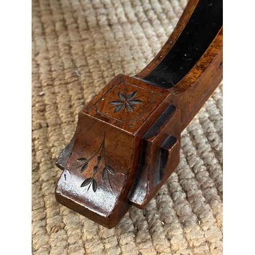 42 - An oval walnut centre table with ebonised inlay and pierced floral detail, on four splayed legs with... 