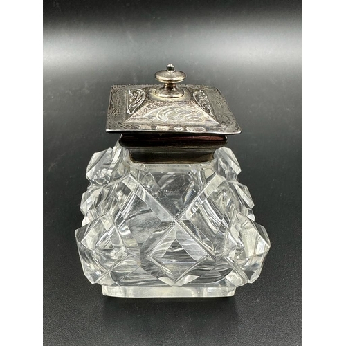 428 - A Victorian cut glass and silver topped inkwell on a pierced silver stand with foliate decoration, h... 