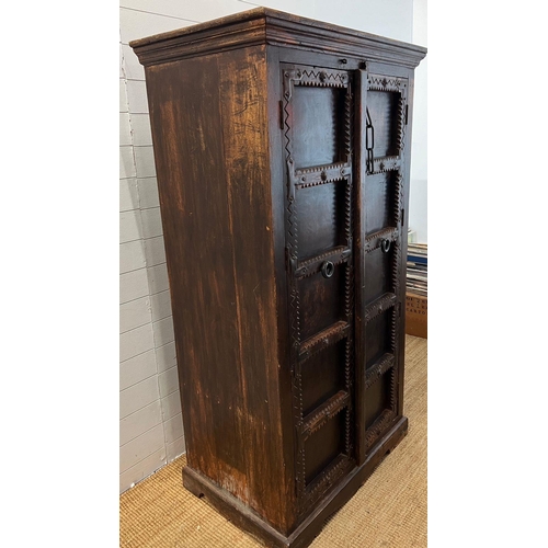 46 - An oriental cabinet with two panelled doors opening to shelves and iron work handles (H174cm W100cm ... 