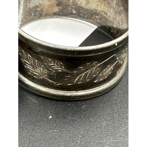 466 - A silver napkin ring and one white metal napkin ring