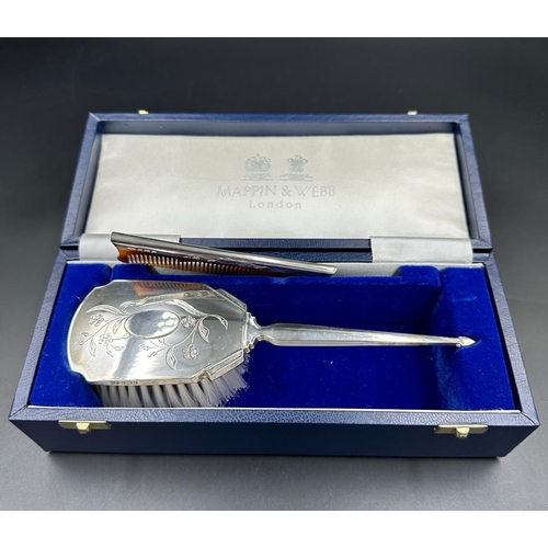 468 - A Mappin and Webb hallmarked Child's silver brush and comb set, cased with original receipt.