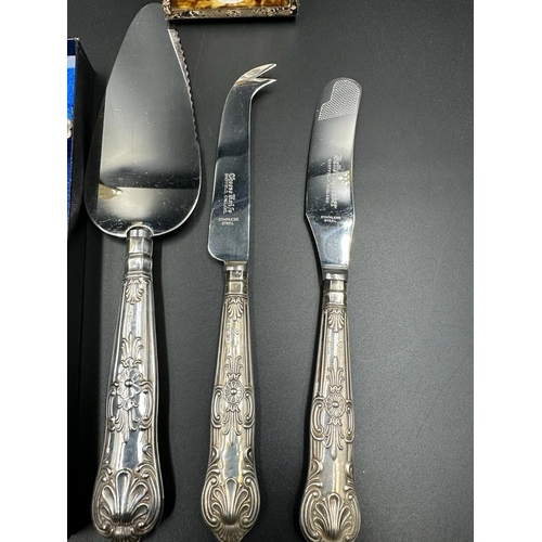 473 - A small selection of silver handled flatware and a silver framed photo frame.