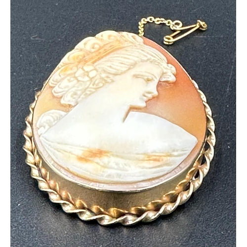 547 - A 9ct gold Cameo of a lady in classical pose, 48mm long.