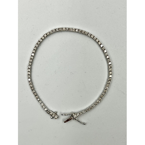 555 - An 18ct white gold Tennis or line bracelet set with approximately 3ct of diamonds.