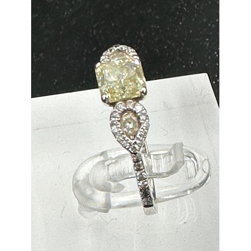 556 - An 18ct white gold decoartive ring set with 1.28ct fancy natural colour radiant cut diamond, certifi... 