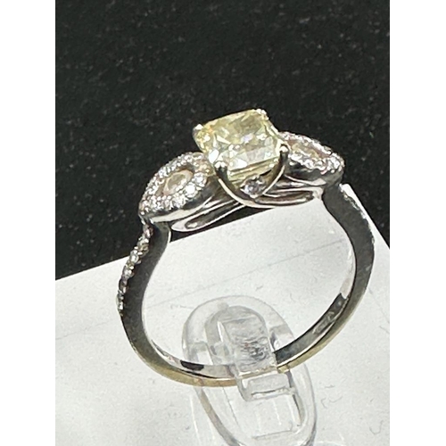 556 - An 18ct white gold decoartive ring set with 1.28ct fancy natural colour radiant cut diamond, certifi... 