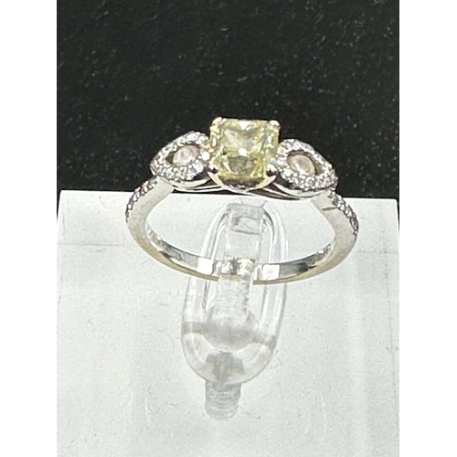 556 - An 18ct white gold decoartive ring set with 1.28ct fancy natural colour radiant cut diamond, certifi... 