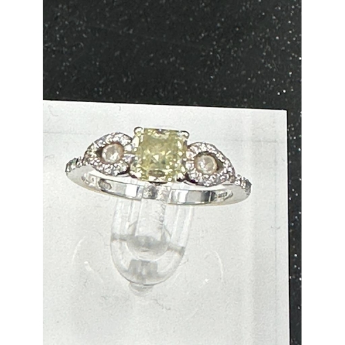 556 - An 18ct white gold decoartive ring set with 1.28ct fancy natural colour radiant cut diamond, certifi... 