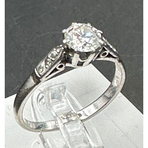 558 - A single stone diamond ring with diamond set shoulders. Round Brilliant cut diamond 0.64ct, Colour F... 