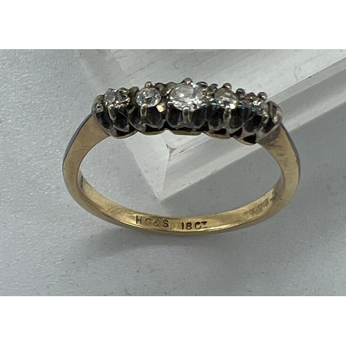 573 - An 18ct five stone diamond ring, approximate size N