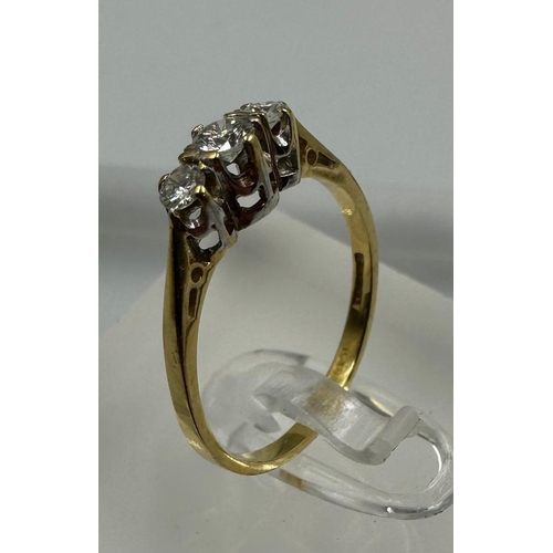 575 - An 18ct three stone diamond ring, approximate size M1/2