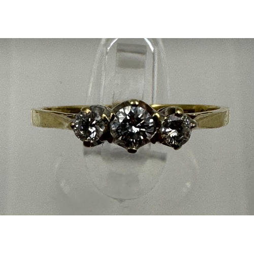 575 - An 18ct three stone diamond ring, approximate size M1/2