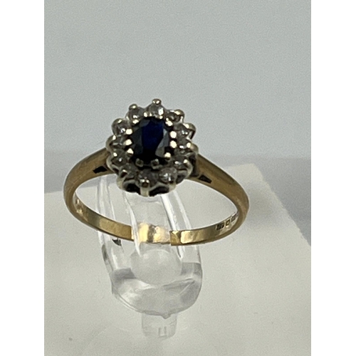 581 - A 9ct gold ring with diamonds and central sapphire Size J