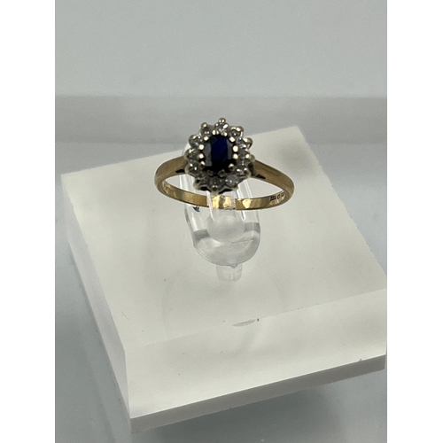 581 - A 9ct gold ring with diamonds and central sapphire Size J