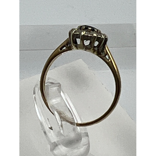 581 - A 9ct gold ring with diamonds and central sapphire Size J