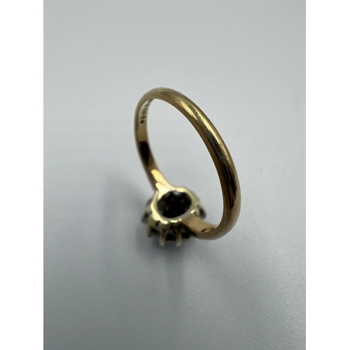 581 - A 9ct gold ring with diamonds and central sapphire Size J